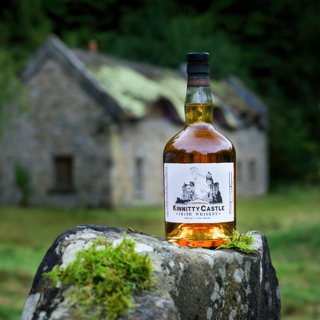 kinnitty castle irish whiskey dapper blend in front of whiskey tasting cottage